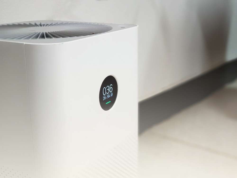 Closeup of an air purifier on the floor.