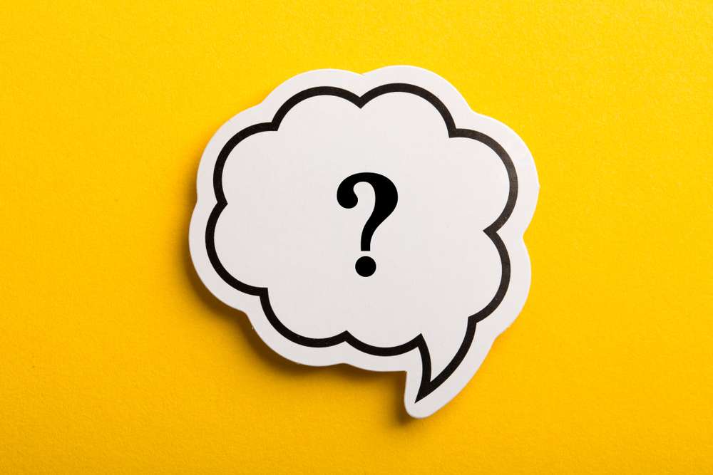 Speech bubble with a question mark inside it on a yellow background.
