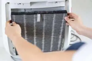 Person changing a hepa filter in their air purifier